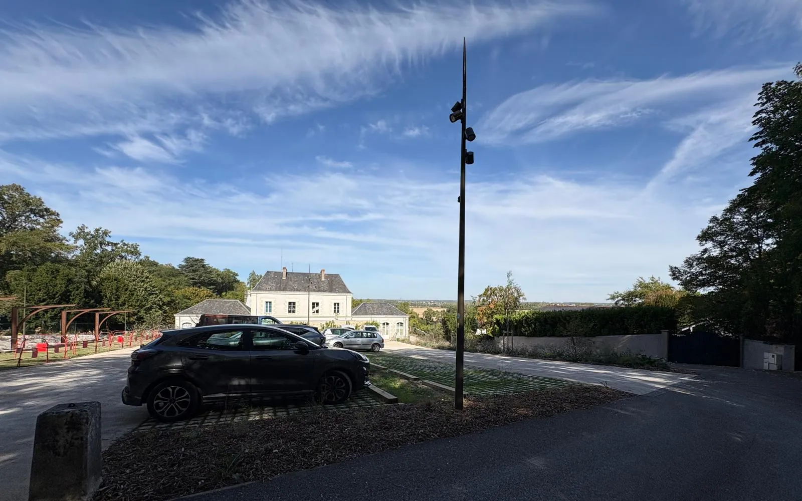 Mât à projecteurs éclairant le parking de Véretz, ciel voilé